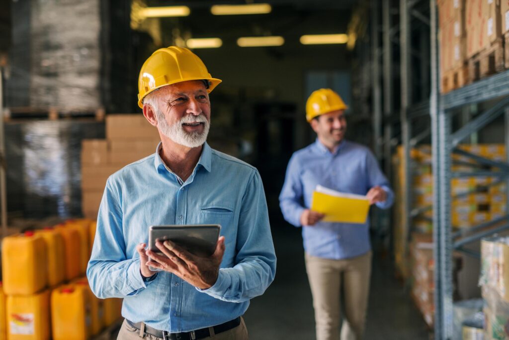 Picture of father and son walking through their warehouse with h