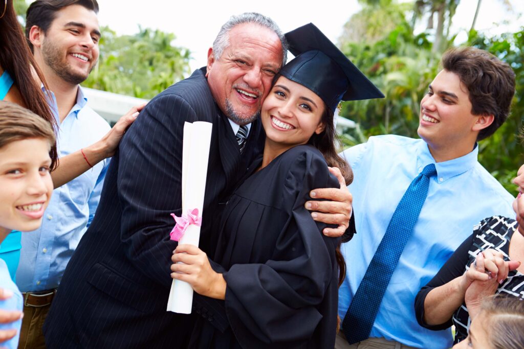 Hispanic Student And Family Celebrating Graduation